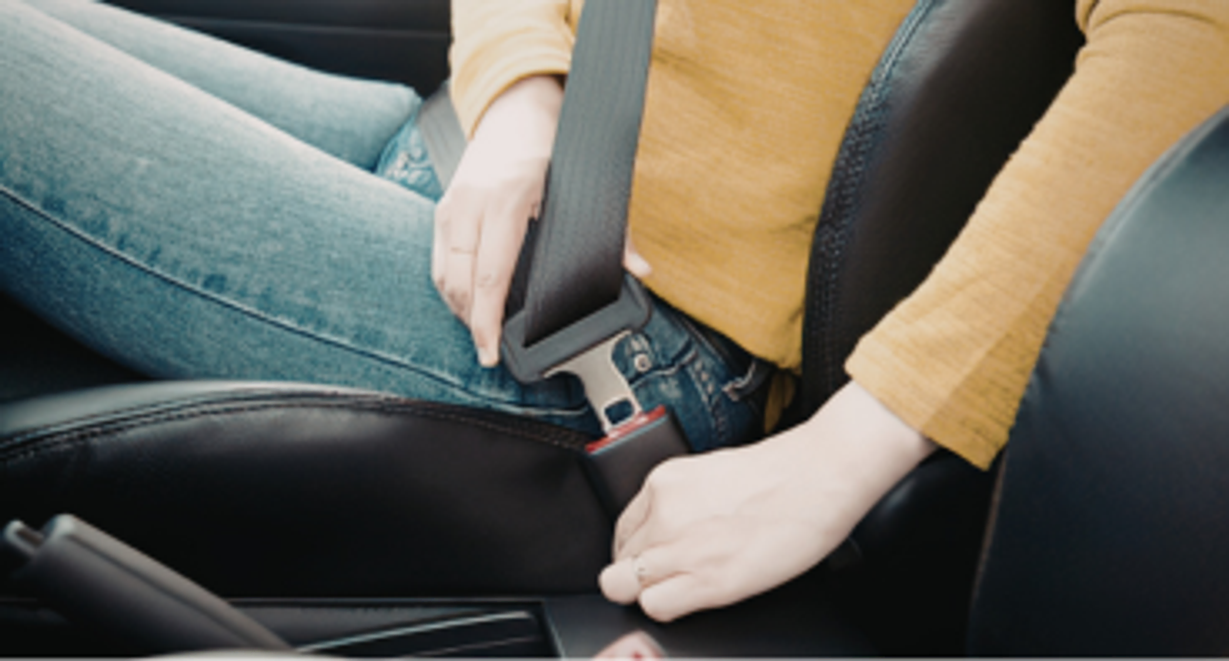 Woman using seatbelt in a car